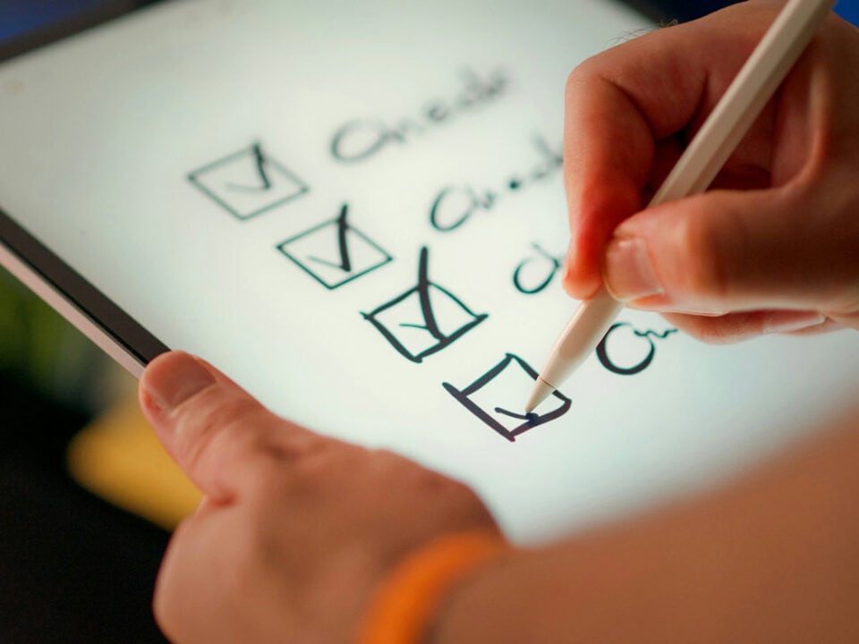 A checklist on a digital device for delegated credentialing being checked off
